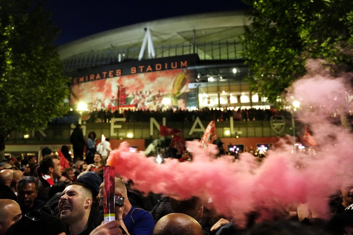 Arsenal players greeted by fans in early hours of morning outside Emirates Stadium after title party